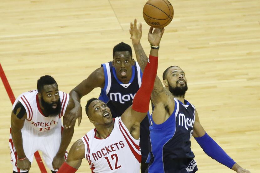 Houston Rockets center Dwight Howard wins a jump ball against Dallas Mavericks center Tyson...