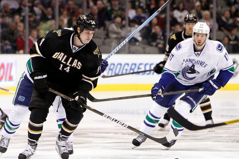 FILE - In this March 22, 2012, file photo, Dallas Stars' Jamie Benn (14) controls the puck...