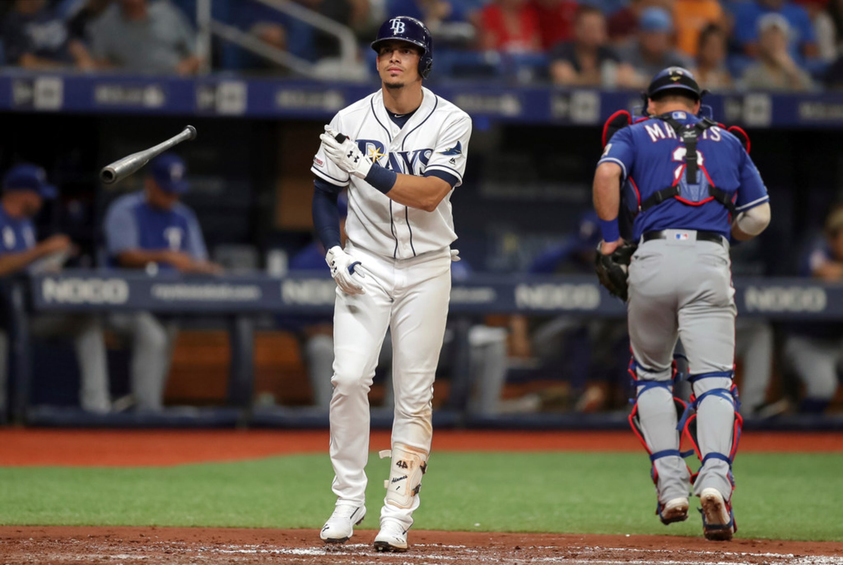 Tampa Bay Rays' Willy Adames reacts after striking out as Texas Rangers catcher Jeff Mathis...