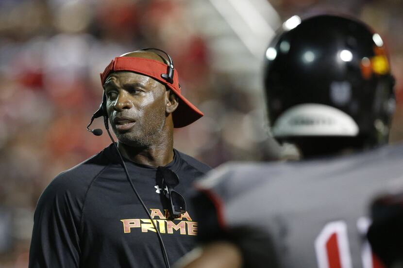AAA Prime U coach Deion Sanders communicated with his players during a high school football...