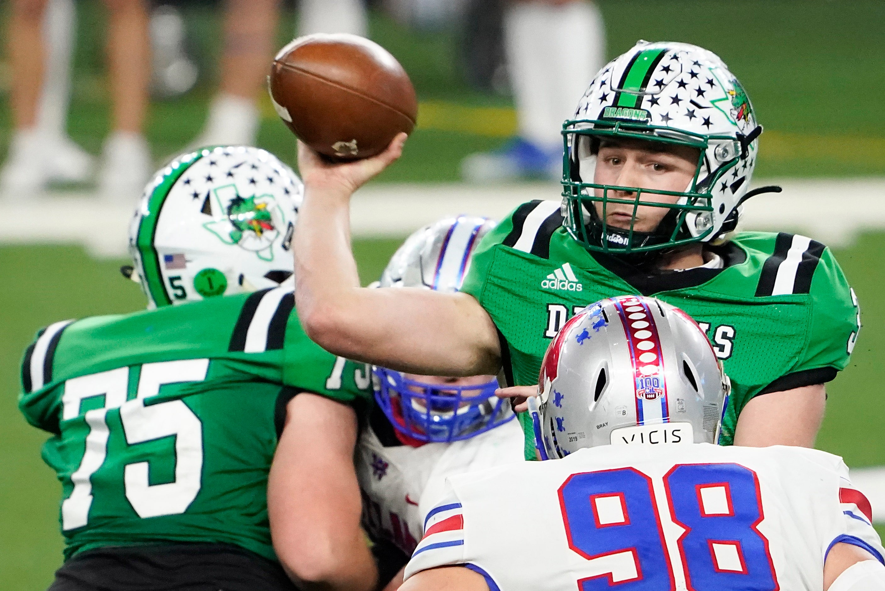 Southlake Carroll quarterback Quinn Ewers (3) throws a pass under pressure from Austin...