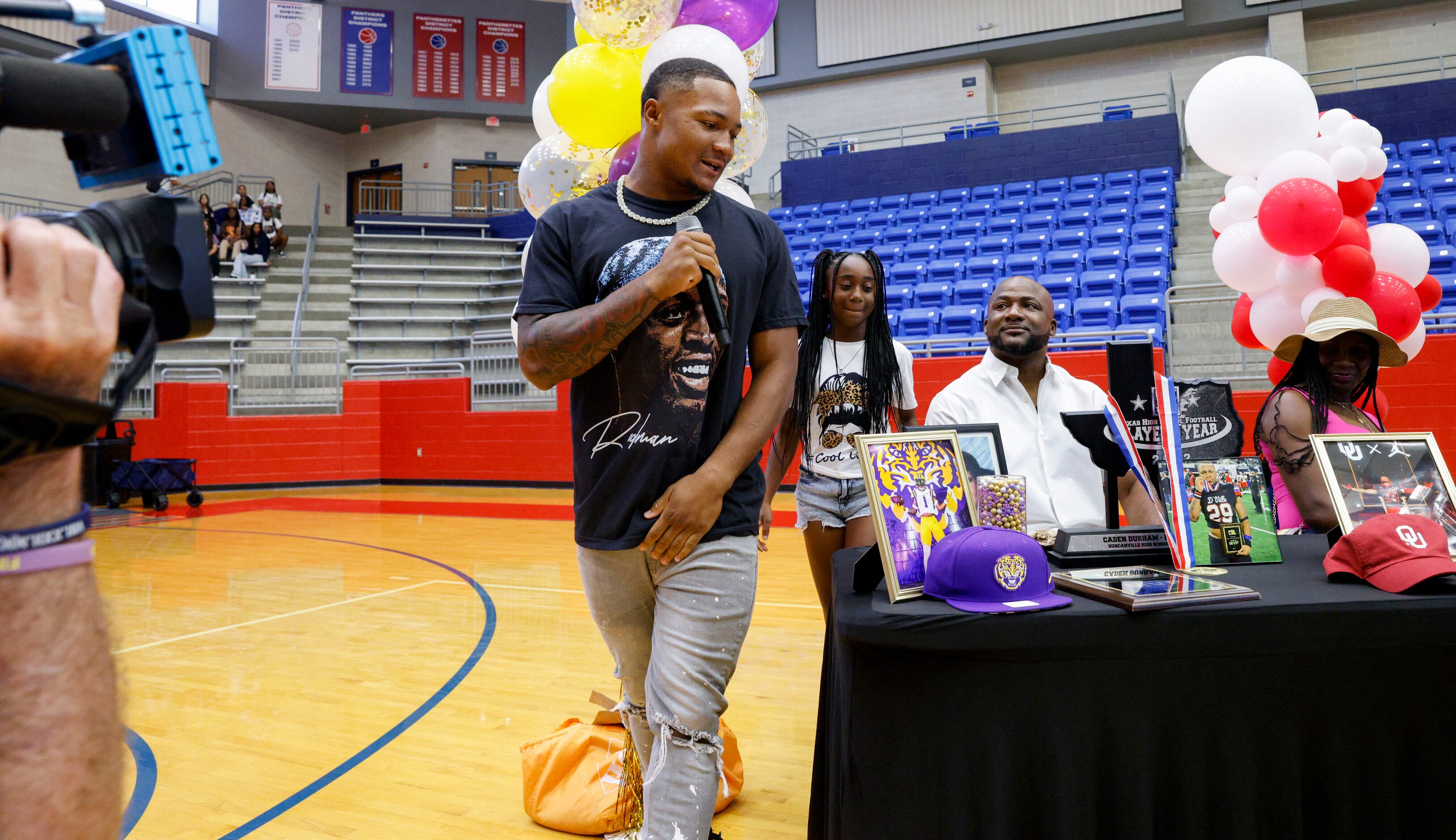 Duncanville running back Caden Durham makes his way to the front of a table to make his...