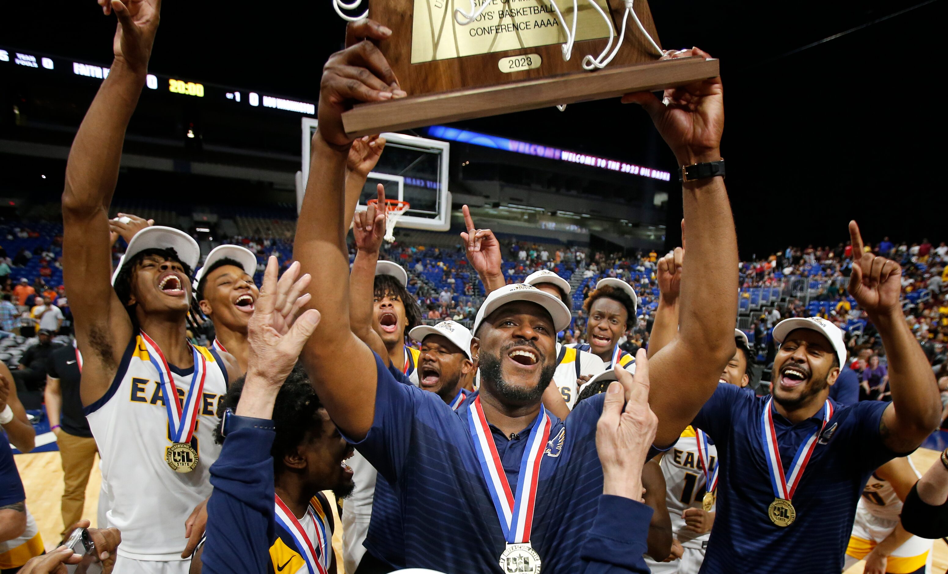 Oak Cliff Faith Family Academy head coach Brandon Thomas holds up their trophy. Dallas Oak...