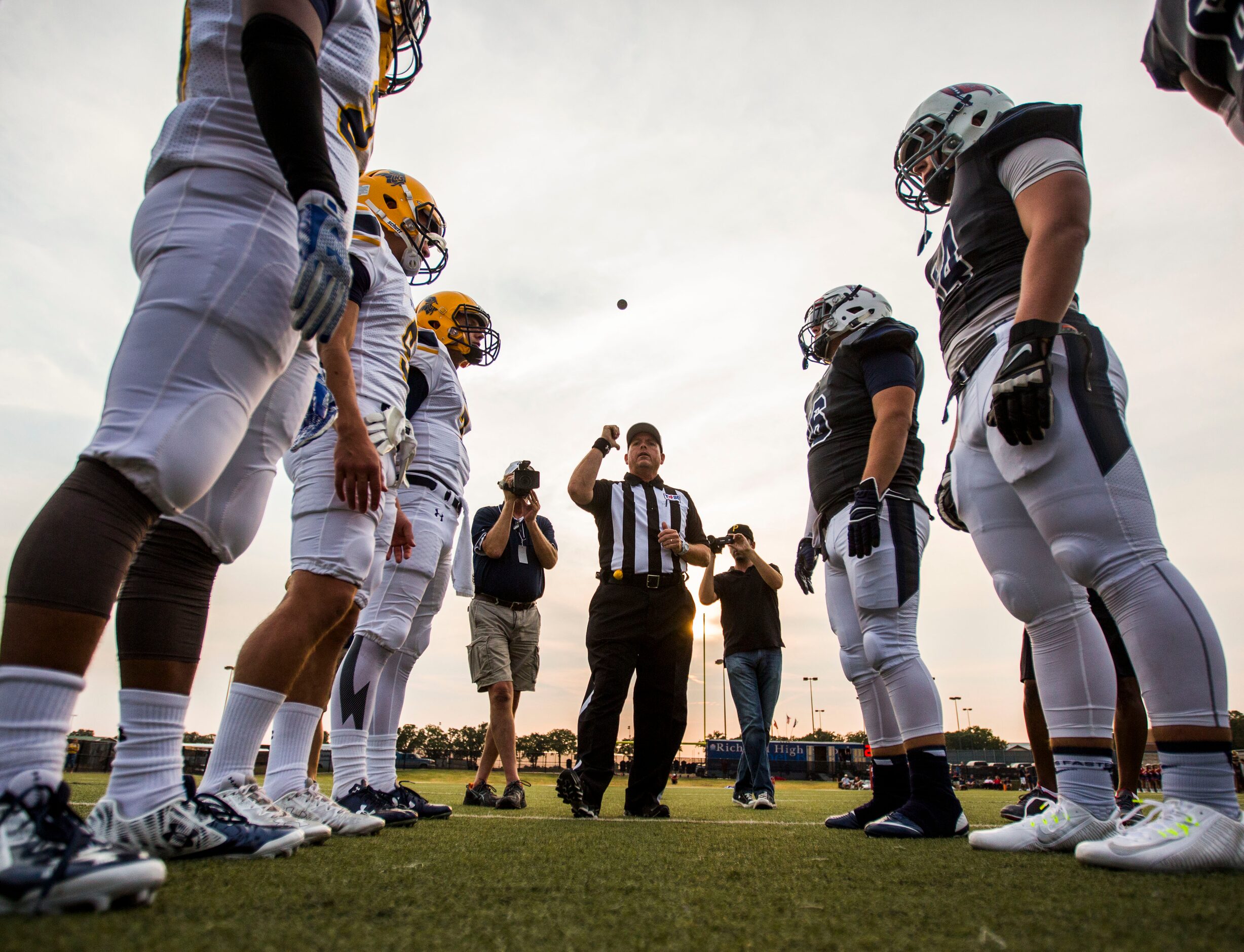 Team captains from Arlington Lamar High School and Richland High School meet for the coin...