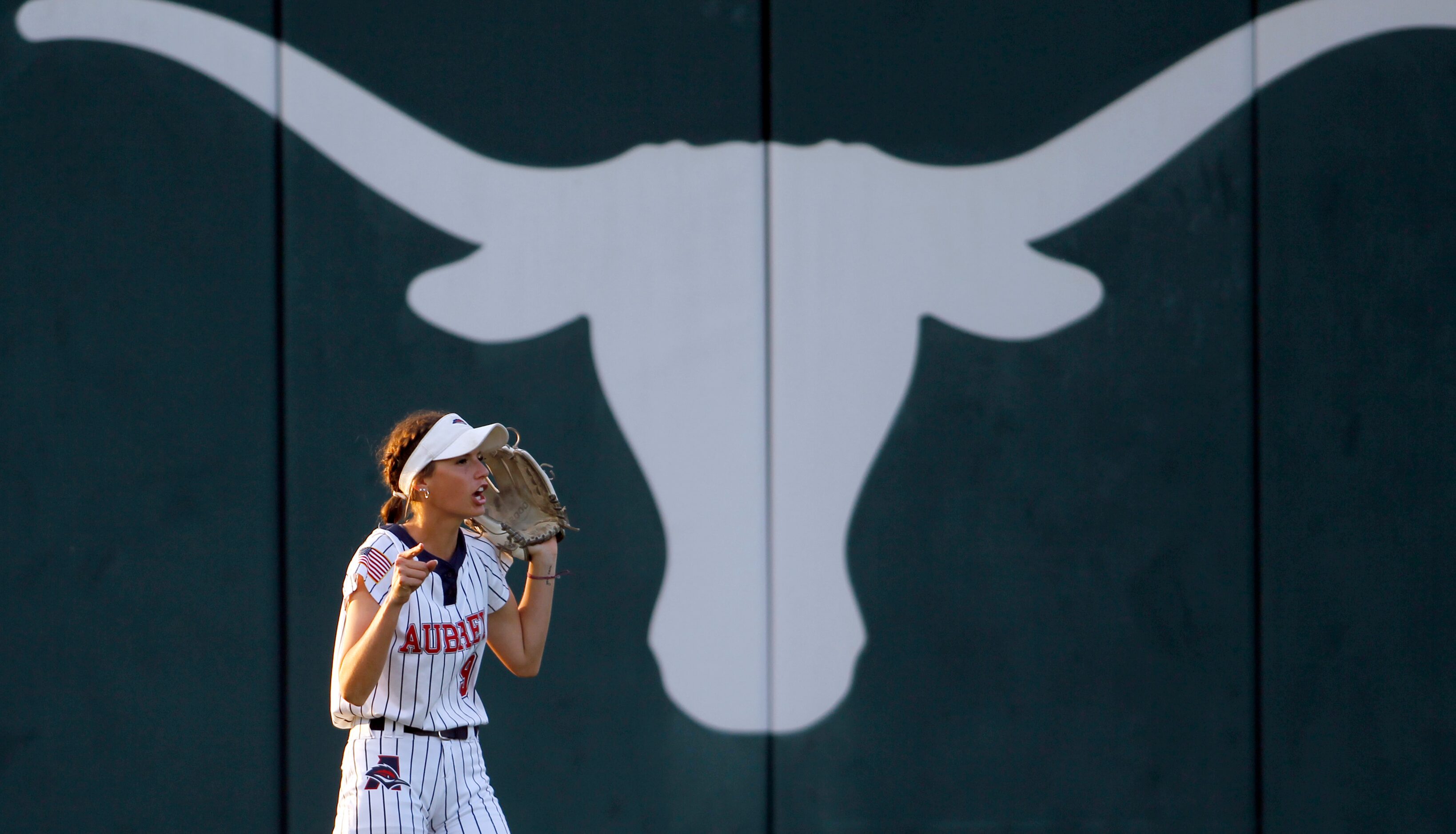 Aubrey left fielder Abby Hemmett (9) yells to a teammate between batters during the top of...