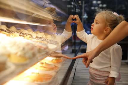 Everlee Pastora, 2, eyes a cookie at the new Celebrity Bakery in Highland Park. 