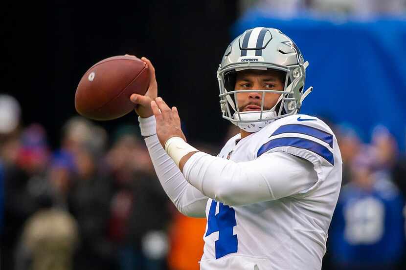 Dallas Cowboys quarterback Dak Prescott warms before an NFL football game against the New...