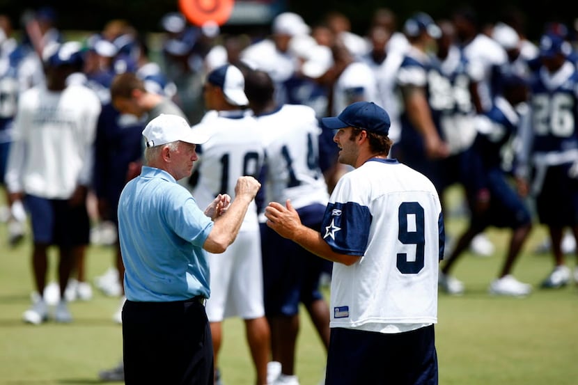 Dallas Cowboys quarterback Tony Romo (9) and owner Jerry Jones discuss throwing technique on...