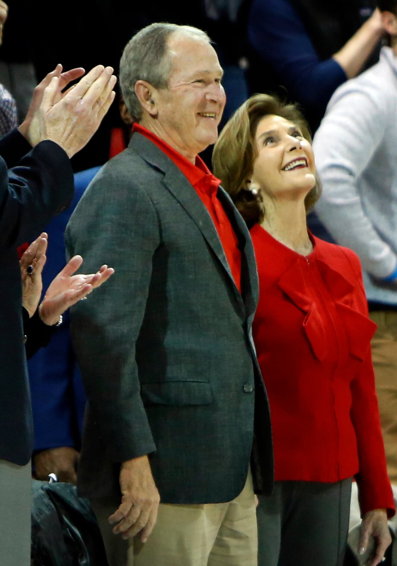 Former president George Bush and his wife Laura beam as they are announced to a welcoming...