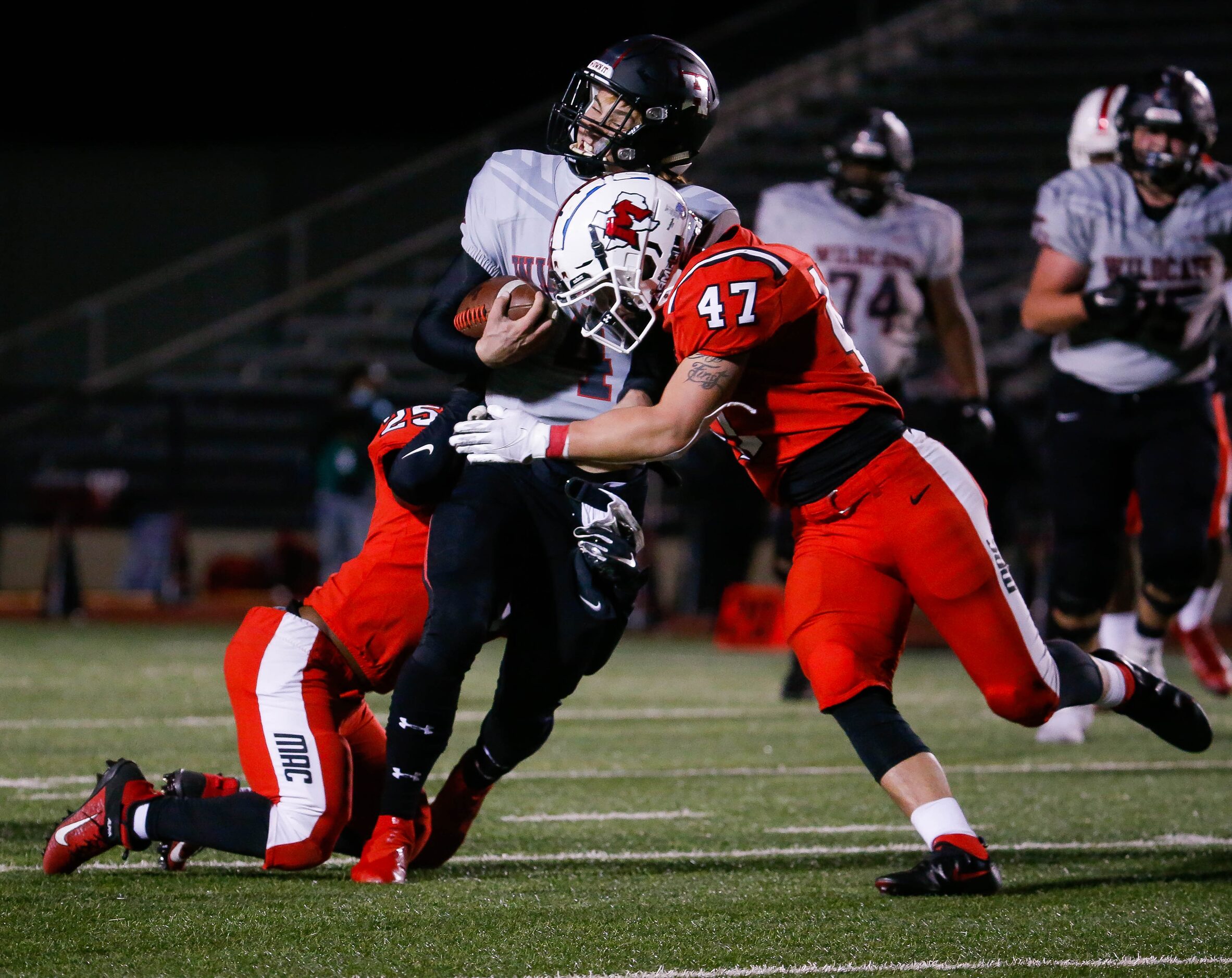 Lake Highlands quarterback Caden Dotson (4) is taken down by the Irving MacArthur defense...