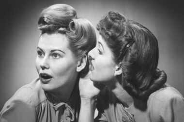 Two women gossiping in studio (B&W)