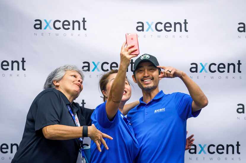 From left: Rose Garza, Tiffany Tran and Oscar Reed posed for a group selfie during a company...