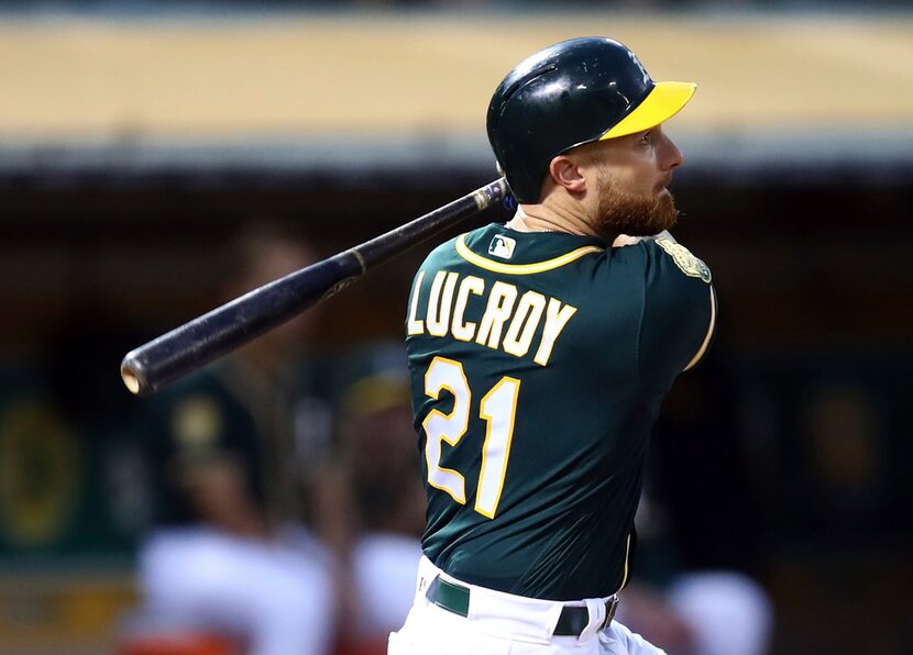 Oakland Athletics' Jonathan Lucroy swings for an RBI sacrifice fly off Toronto Blue Jays'...