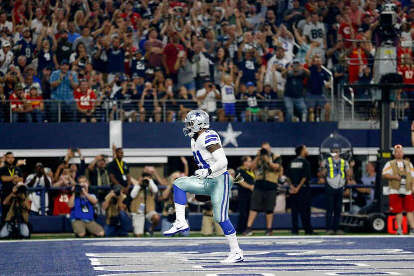 Dallas Cowboys running back Ezekiel Elliott (21) dances across the end zone after scoring a...