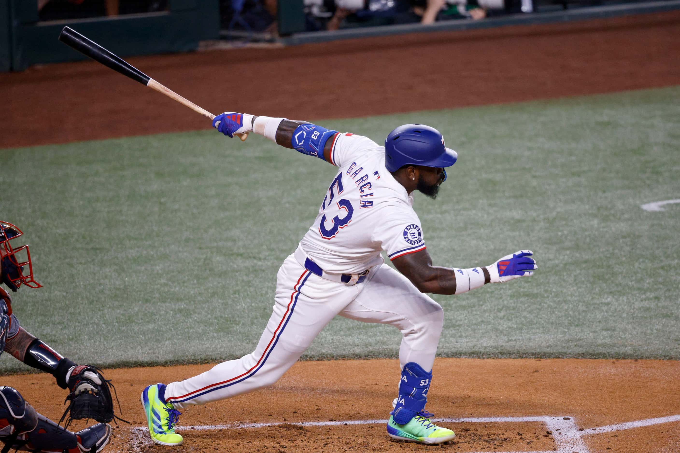 Texas Rangers outfielder Adolis García (53) hits a single during the first inning of a...