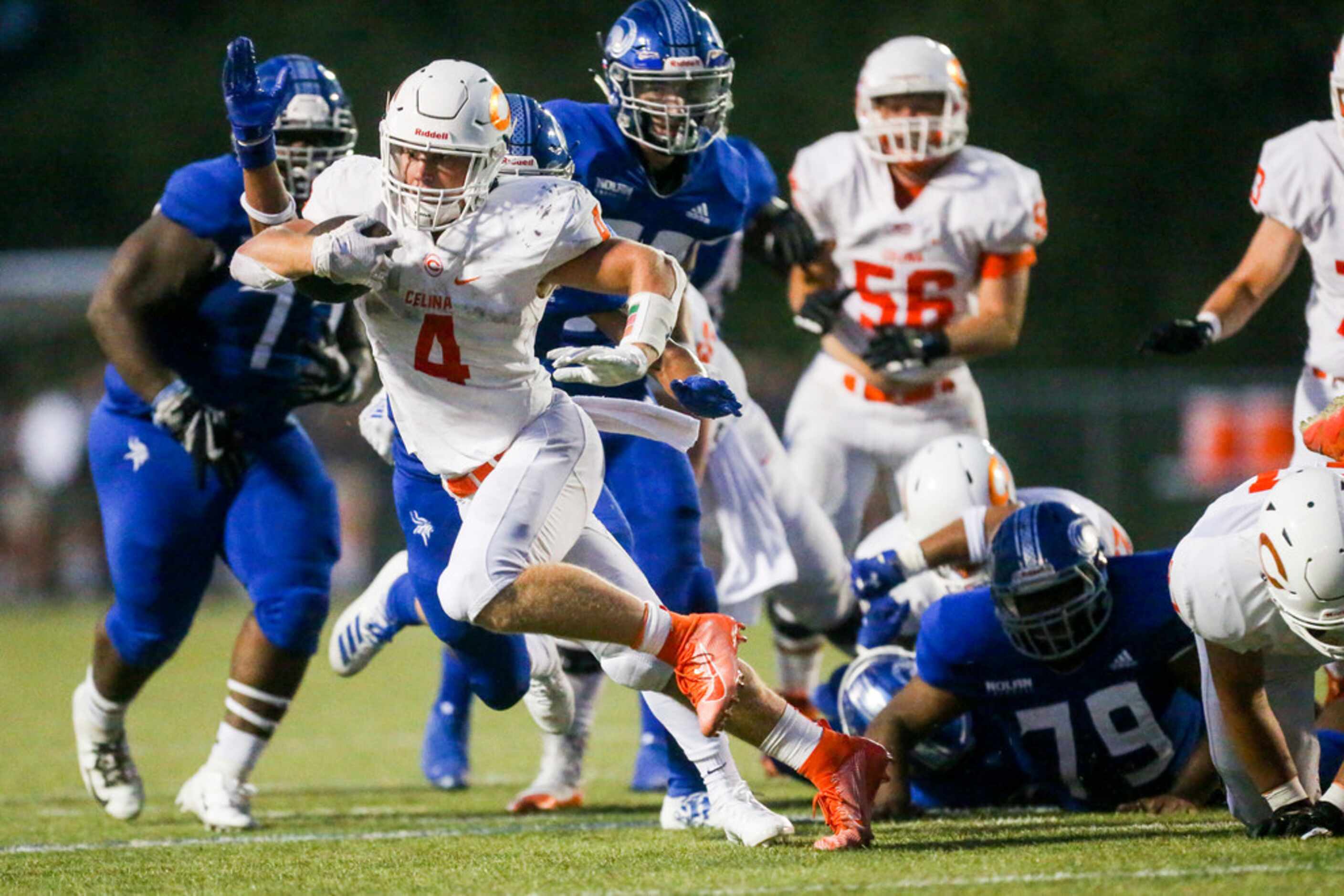 Celina running back Logan Point (4) carries the ball for a 22 yard touchdown during a high...