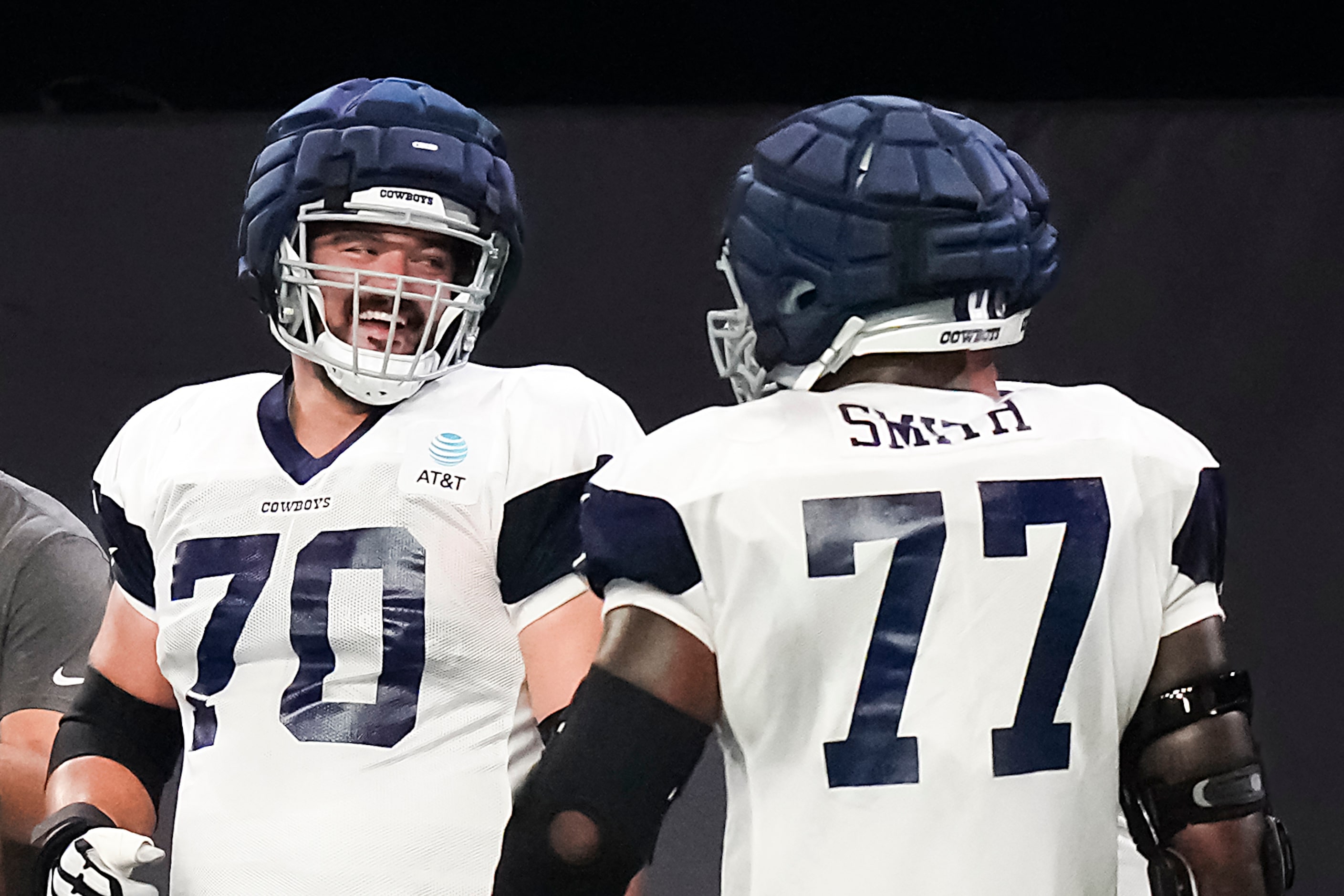 Dallas Cowboys offensive lineman Zack Martin (70) laughs with offensive lineman Tyron Smith...