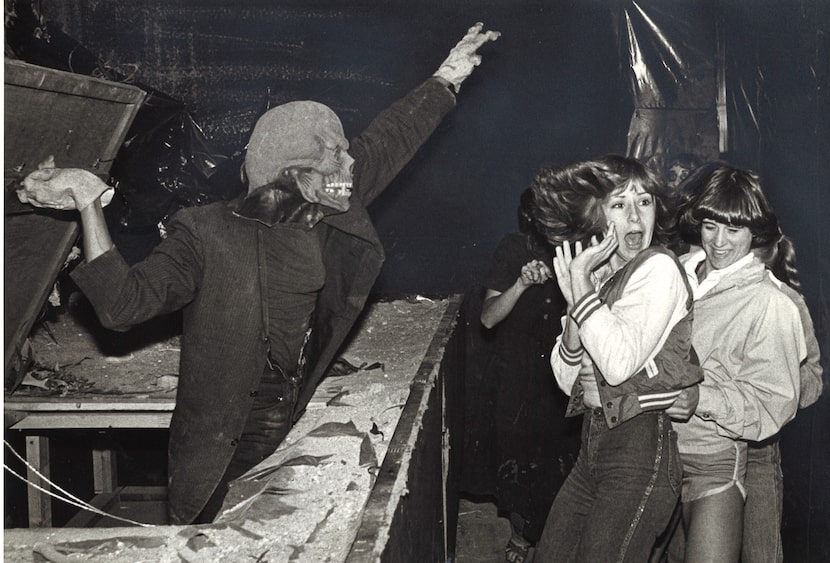 Ghoul Jerry Fleming scares Marie Rossman (center) of Carrollton and Amy Walker at the March...