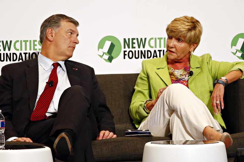 Dallas Mayor Mike Rawlings (left) listened as Fort Worth Mayor Betsy Price talked on a panel...