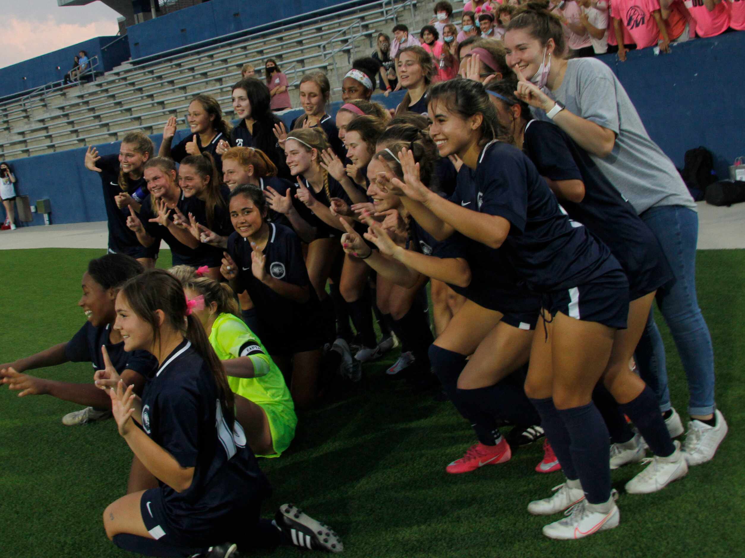 Flower Mound players pose for an impromptu photo on the team sideline following their 3-0...