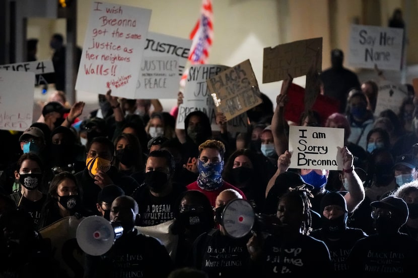 Demonstrators march on Ervay Street near Dallas City Hall after after a Kentucky grand jury...