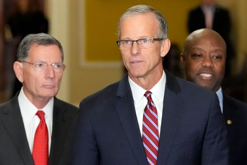 Newly elected Senate Majority Leader John Thune, R-S.D., center, flanked by Sen. John...