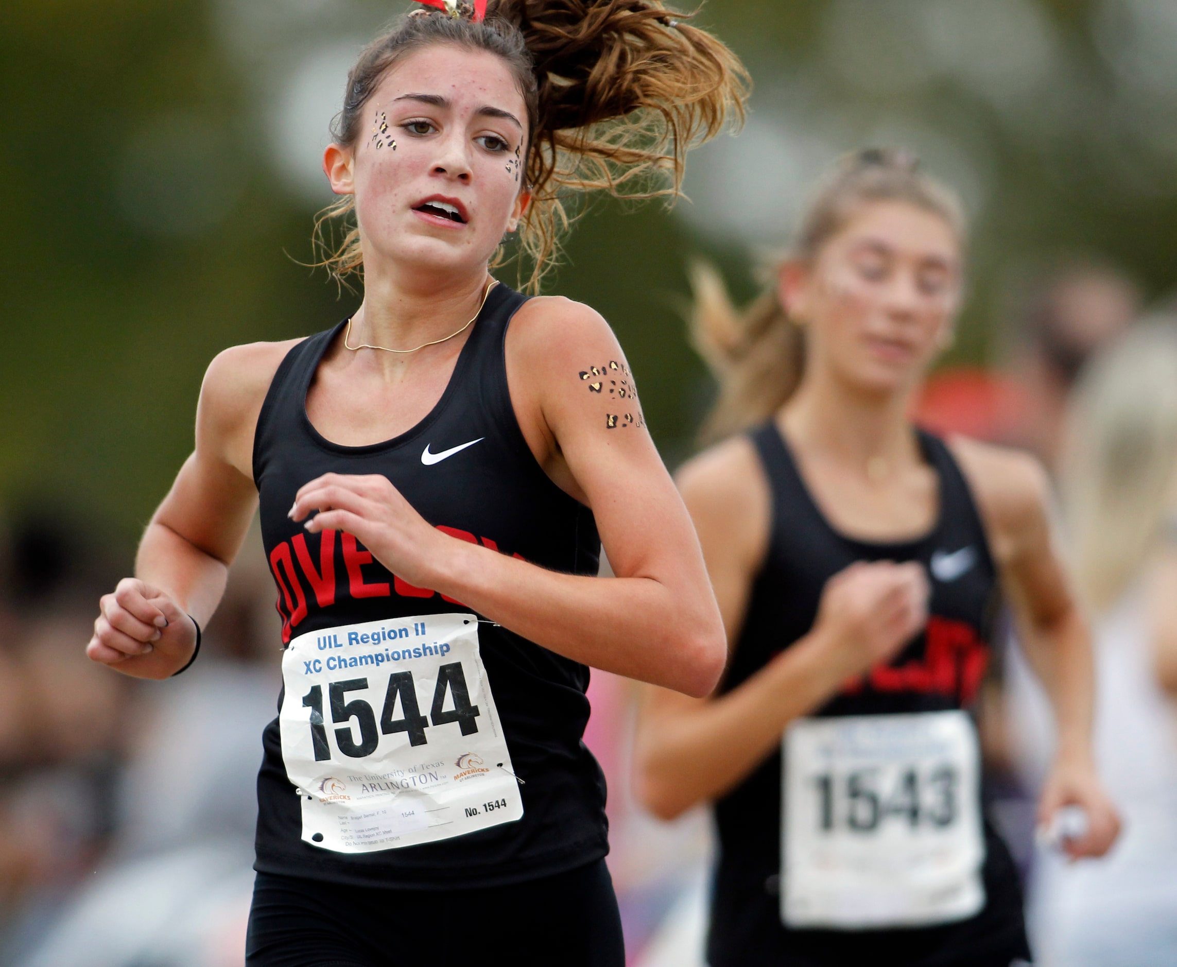 Lucas Lovejoy sophomore Bridget Bernal (1544), left, crosses the finish line in the Girls...