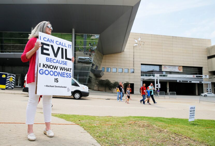 Carol Shelton of Fort Worth holds up a sign as people begin to gather for the "For Such a...