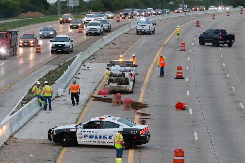 Crews clean up southbound Interstate 35 near the Overton Rd exit early Thursday morning,...