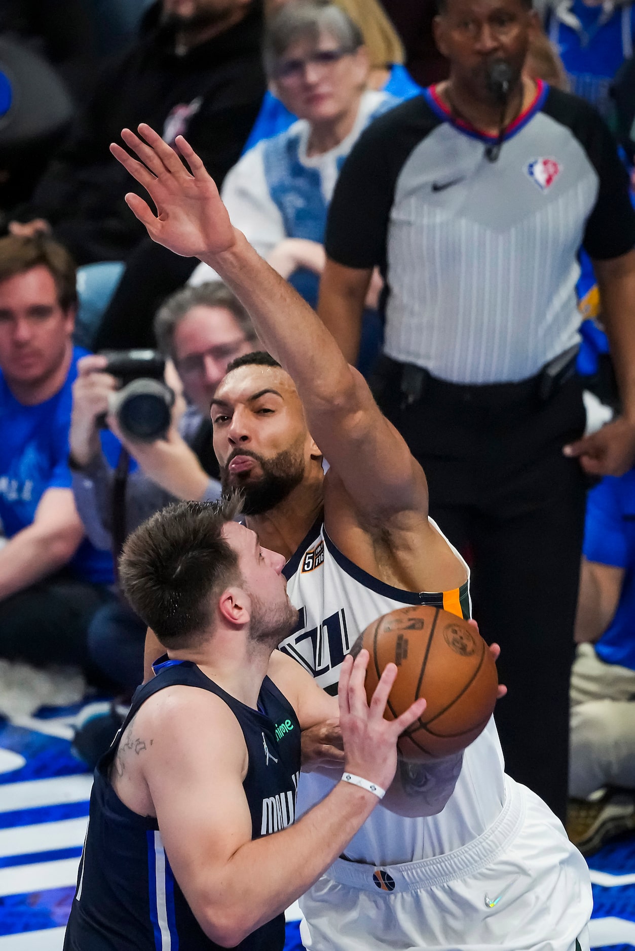 Dallas Mavericks guard Luka Doncic (77) os fouled by Utah Jazz center Rudy Gobert (27)...