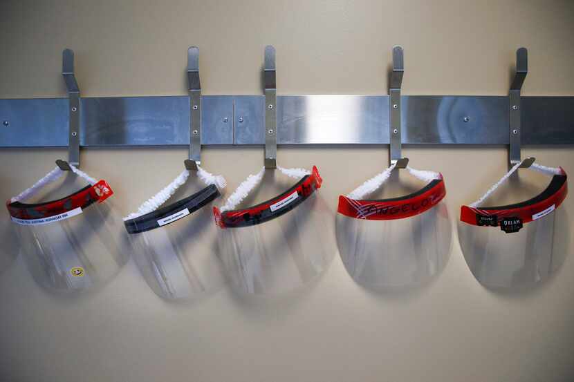 Face shields hang from the wall in the COVID-19 Tactical Care Unit at Parkland Memorial...