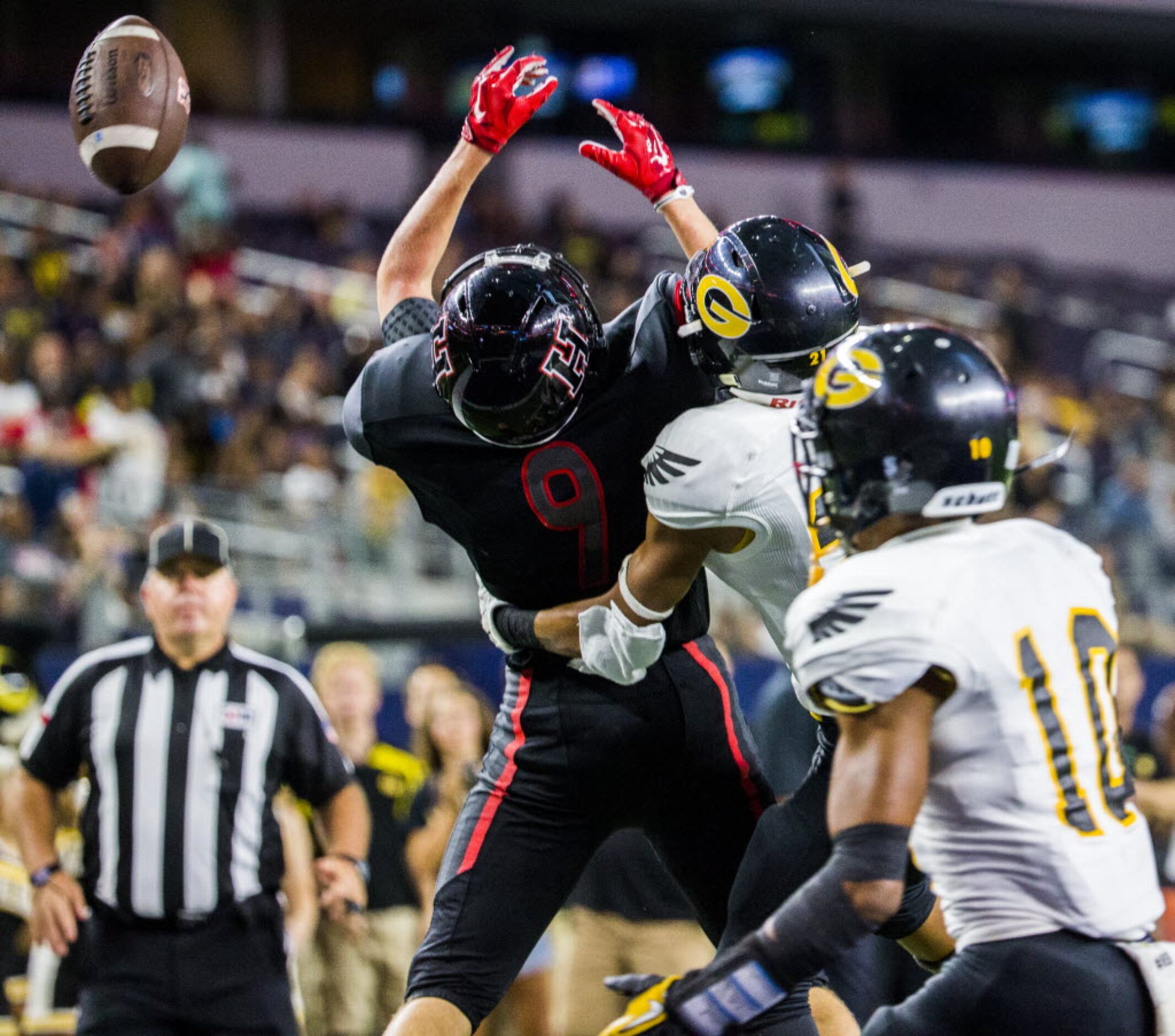 Garland defensive back John Anthony Person (21) tackles Rockwall-Heath's Jackson Salley (9)...