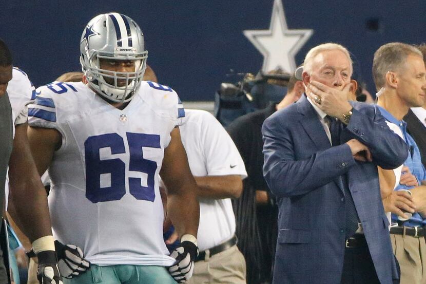 Dallas owner Jerry Jones and Cowboys guard Ronald Leary (65) watch the action from the...