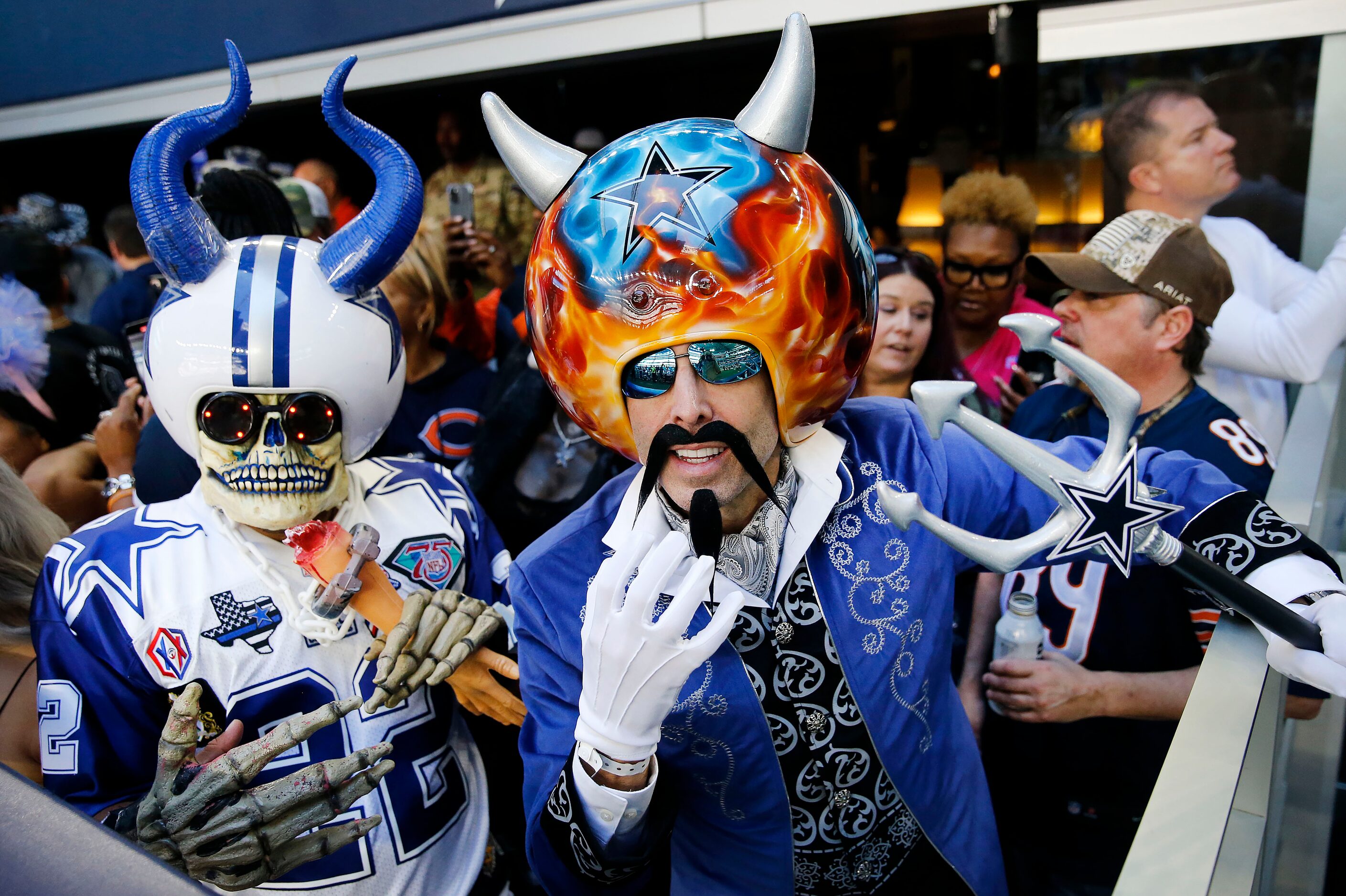 Wreckin' Ball owner and Dallas Cowboys fan Gregg Wilson (right) and other fans dressed the...