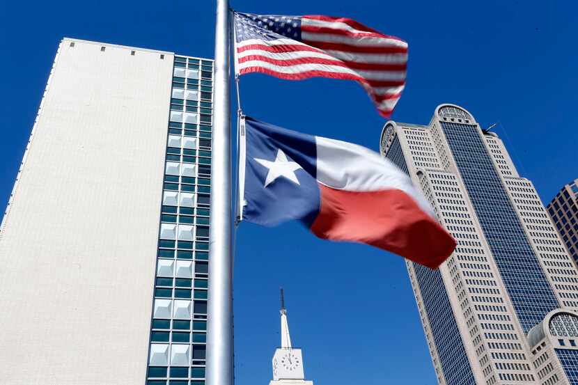 The U.S. and Texas flags fly on Friday, Apr. 26, 2019 in Dallas.