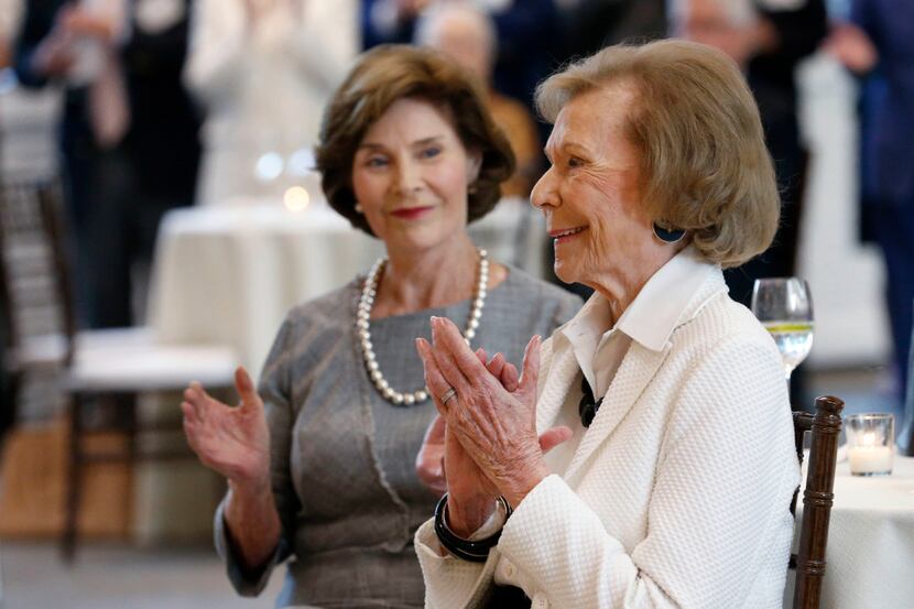 Philanthropist Ruth Altshuler applauds after being honored at a reception with Laura Bush at...
