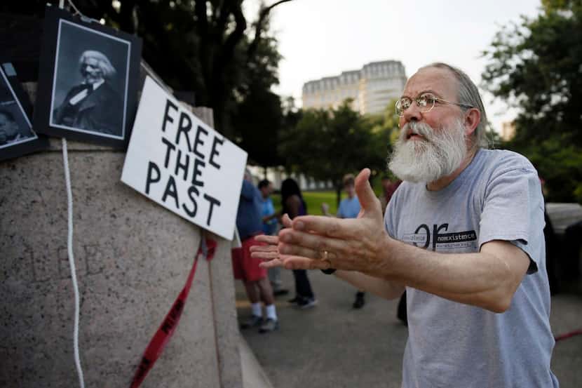 
John Fullinwider led protestors as they gathered around the base of a General Robert E. Lee...