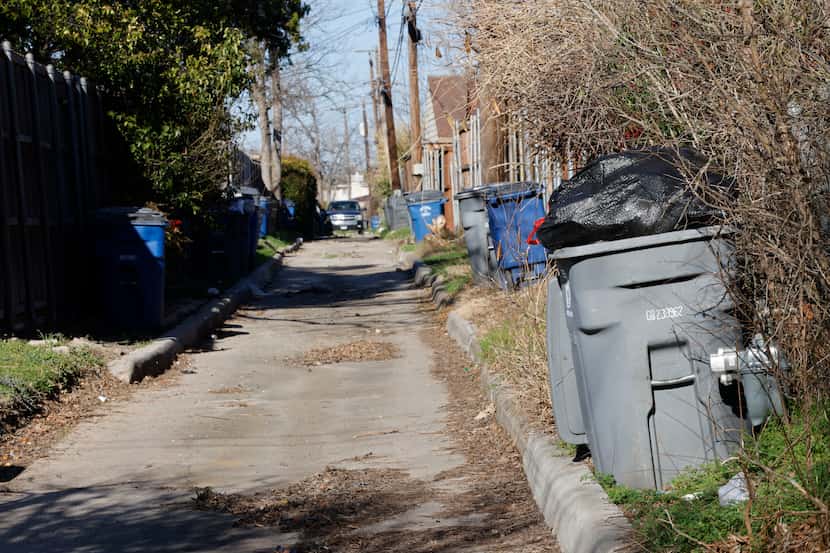 Trash cans are seen on the alley between Bowman Boulevard and Chireno Street, Thursday, Feb....