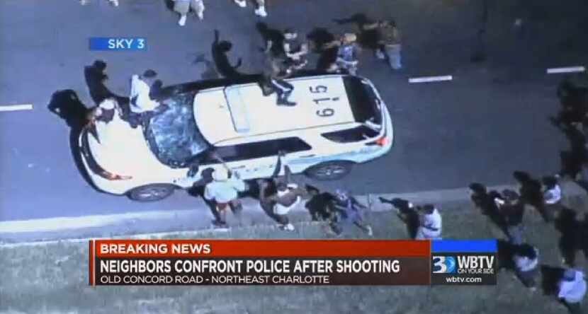 In this frame from video provided by WBTV, a police vehicle is damaged after protests broke...