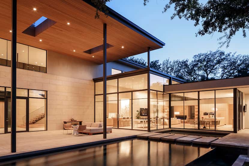  Extensive use of Texas shell stone and panoramic glass walls give the home a warm and...