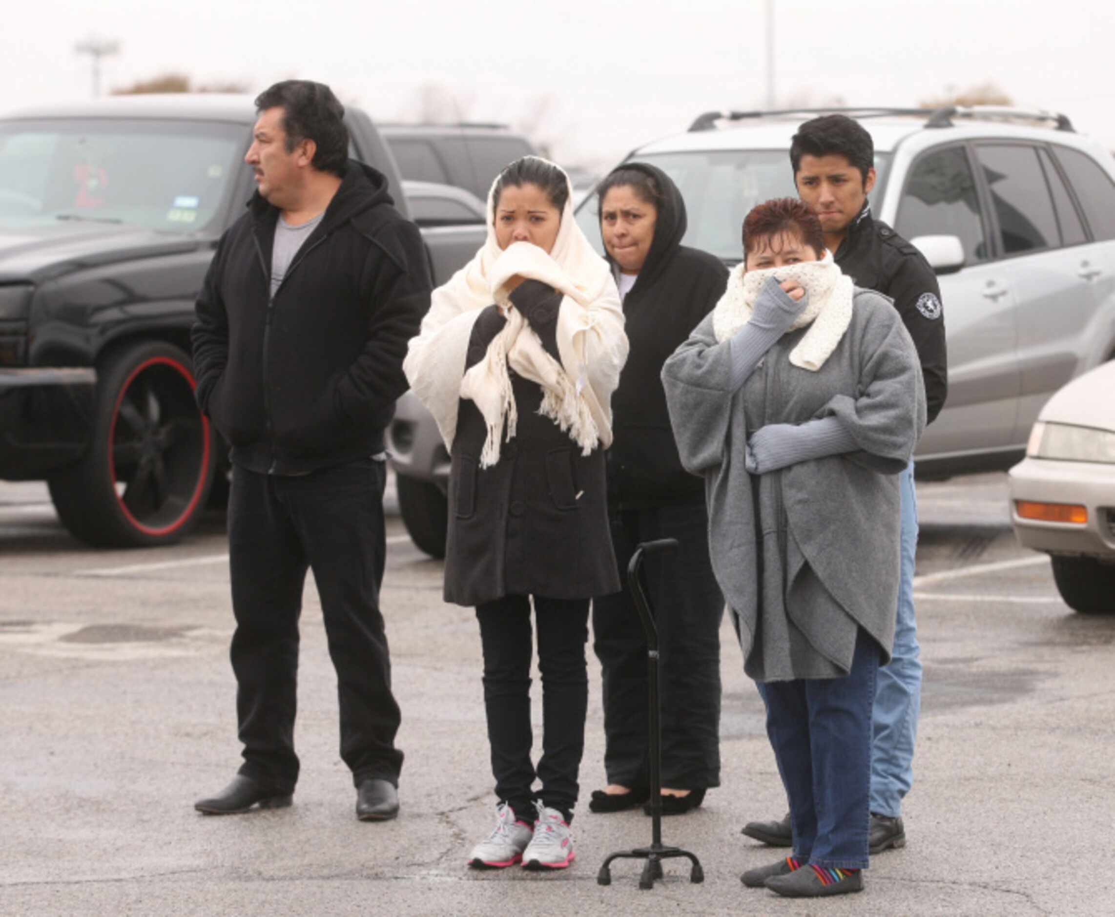 Parents wait for their kids during a lockdown at Arlington Lamar High School due to a report...