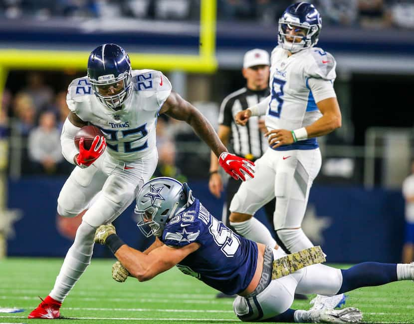 Tennessee Titans running back Derrick Henry (22) carries the ball past Dallas Cowboys...