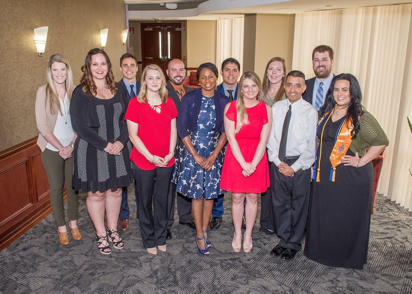 Cassie Valera (second from the left) poses for a portrait with other nursing graduates...