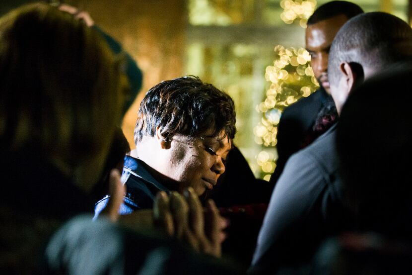 Family members gather around Jacqueline Craig  before a press conference outside the Fort...