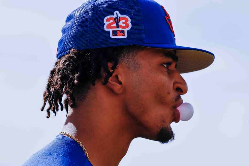 Texas Rangers pitcher Marc Church blows a bubble during a spring training workout at the...
