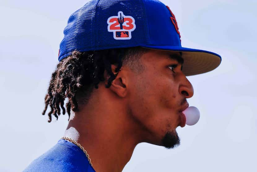 Texas Rangers pitcher Marc Church blows a bubble during a spring training workout at the...