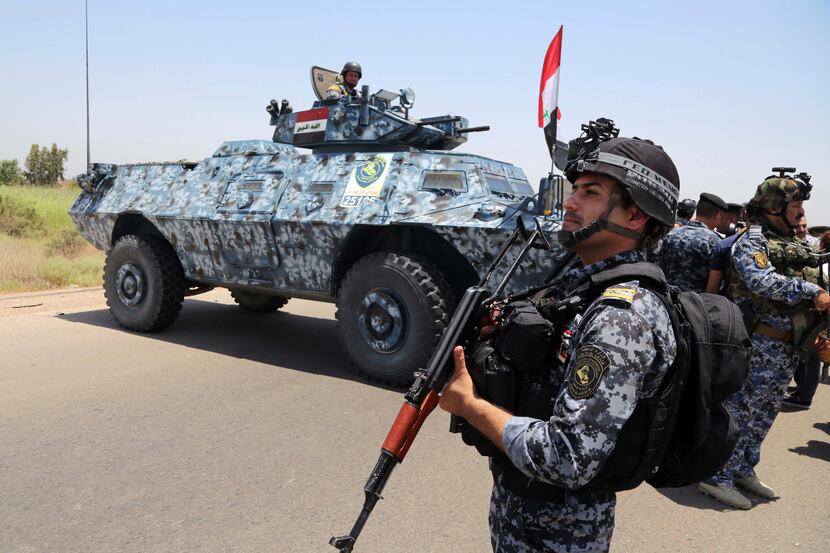 Iraqi federal policemen patrol in Baghdad's Abu Ghraib suburb, Iraq, Saturday, June 28,...