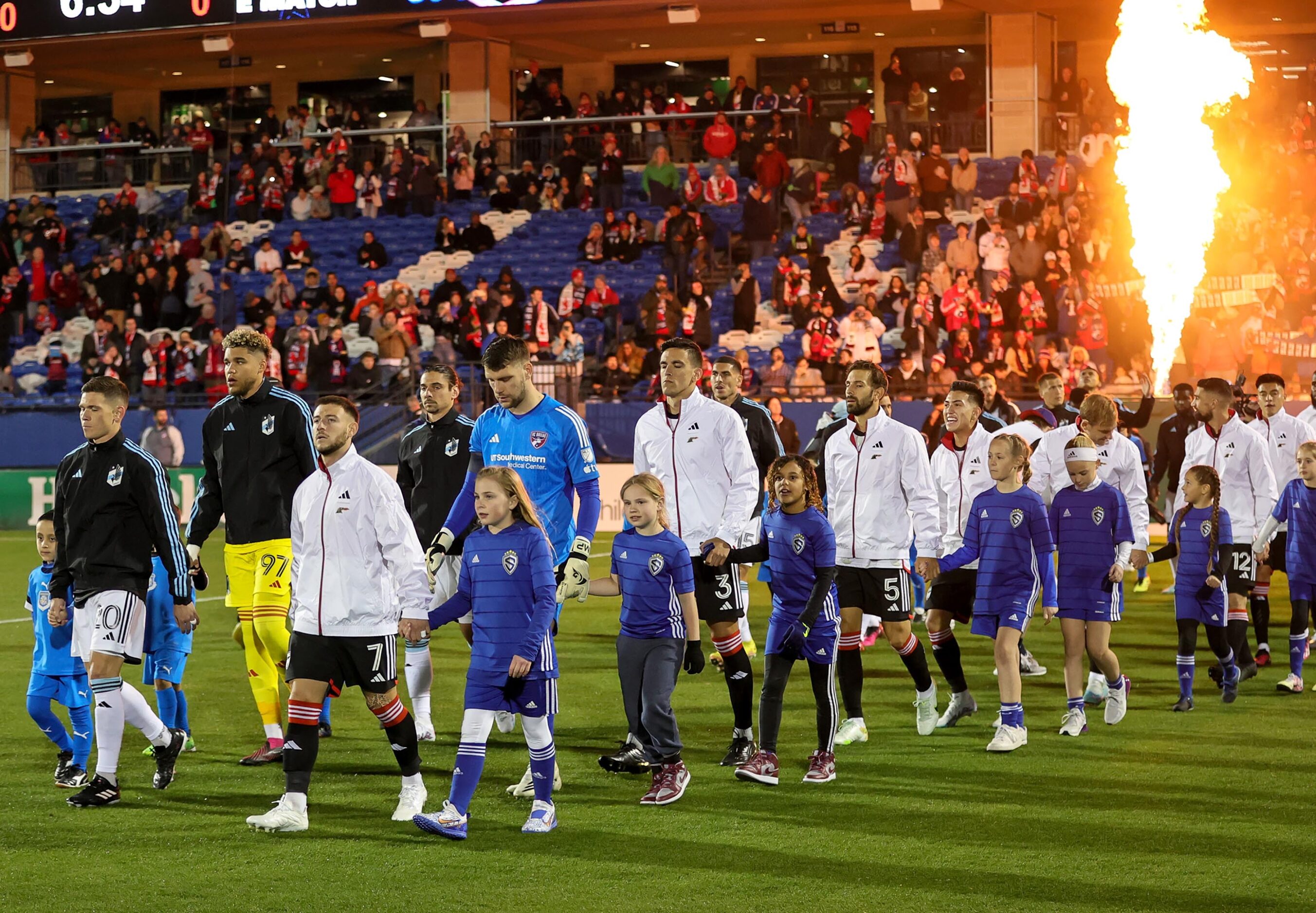 FC Dallas and Minnesota United walk onto the field for the season opener played on February...