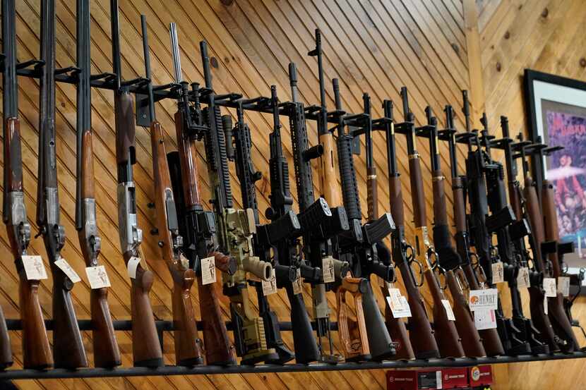 Various guns are displayed at a store on July 18, 2022, in Auburn, Maine. Most U.S. adults...