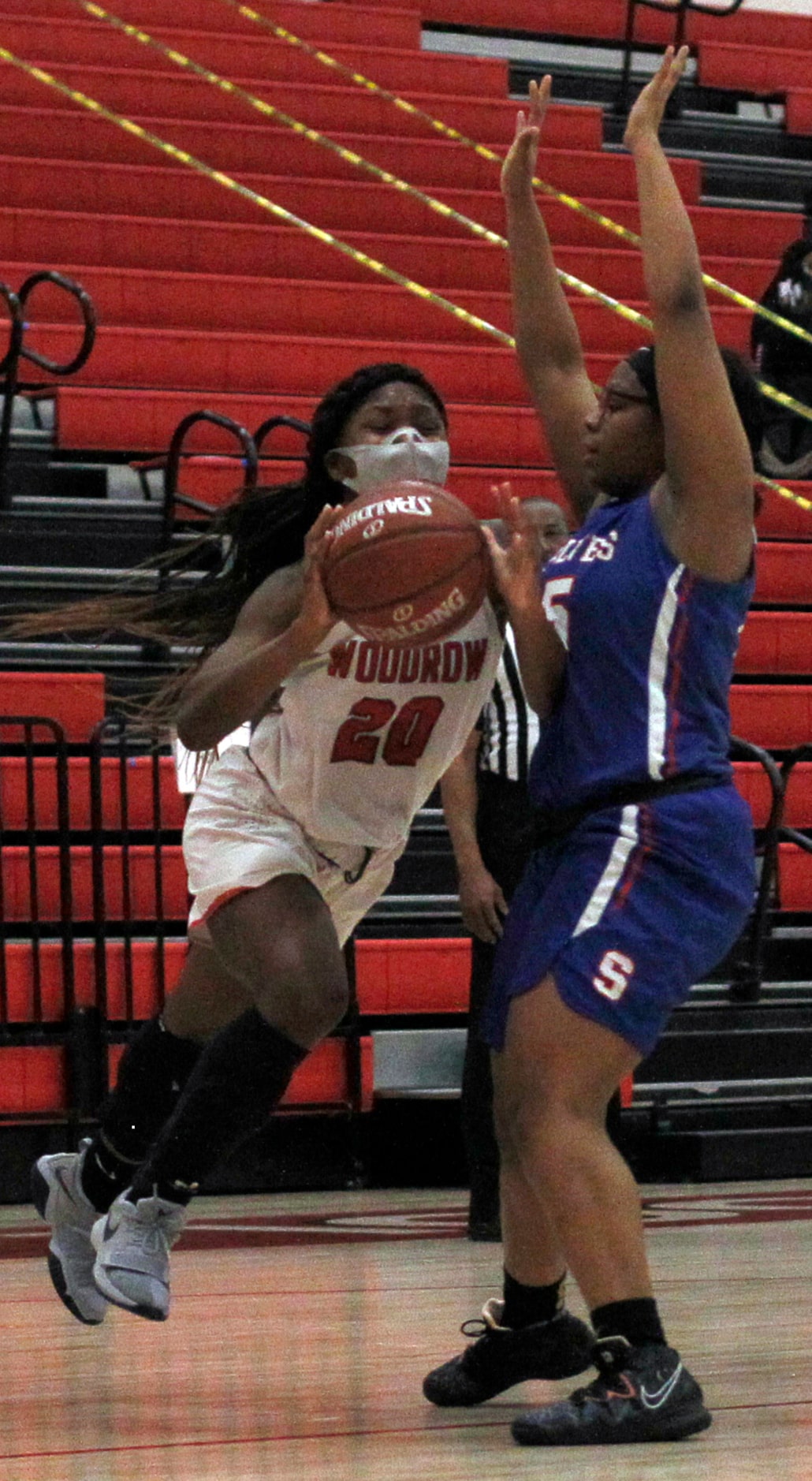 Dallas Woodrow Wilson's A'nyah Peters (20) drives to the basket past the defense of Dallas...